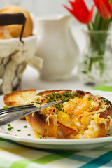 Baked sandwich with egg, cheese and ham.