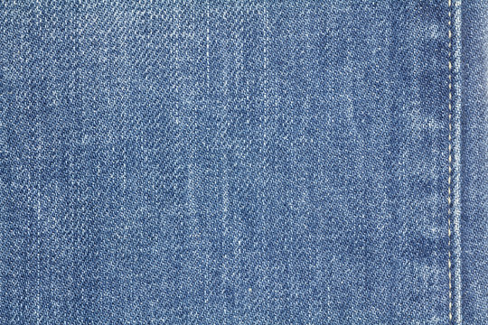 Denim jeans texture or denim jeans background with seam. Old grunge vintage denim jeans. Stitched texture denim jeans background of jeans fashion design.