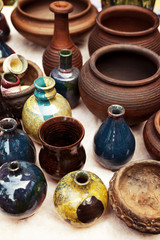 Lots of handmade earthenware - ceramic pots and vases at pottery shop. Colorful clayware background