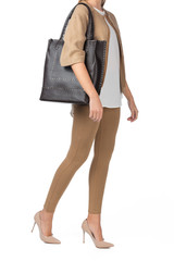 Woman holding a handbag isolated on white background