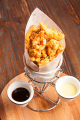 Breaded chicken pieces in a paper bag