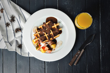 Belgium waffles with fresh berries and chocolate sauce