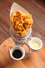 Breaded chicken pieces in a paper bag