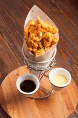 Breaded chicken pieces in a paper bag