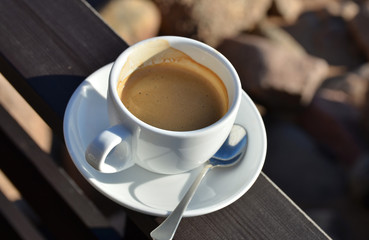 Close up of coffee cup on terrace  in sunny  day. Concept for relax or break.