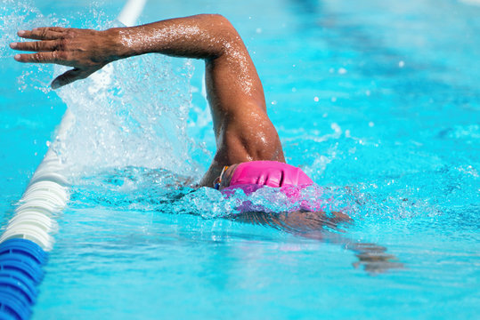 Man swimming the front crawl in a pool