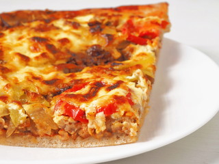 Pizza close up. Fresh homemade pizza with pork, tomatoes, pepper, cheese etc. Selective focus.