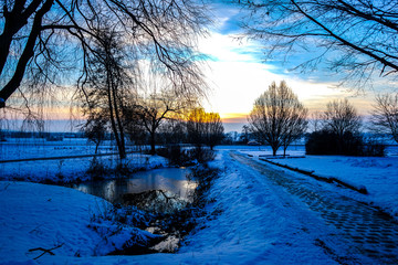 View of a sunset over a winterly landscape