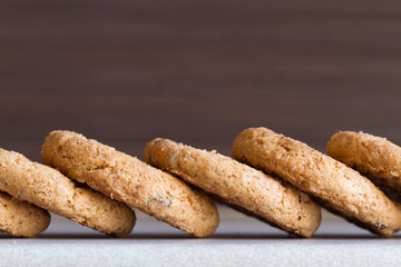 Several chocolate chip cookies on dark background. Close-up