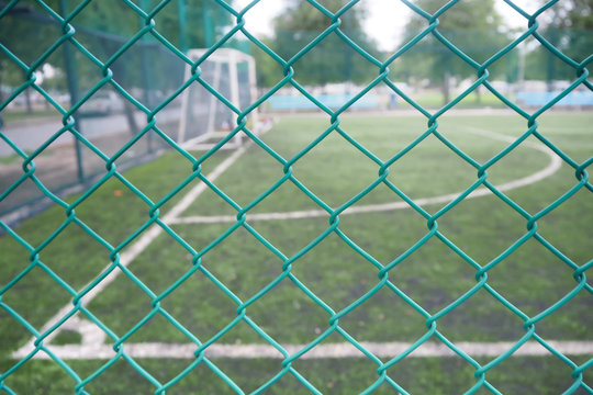 Wire mesh fence in soccer field.