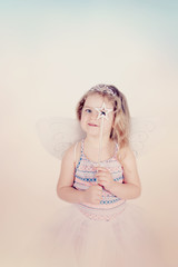 Obraz na płótnie Canvas joyful little funny girl in a butterfly costume