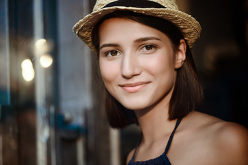 Young beautiful brunette girl in hat smiling.
