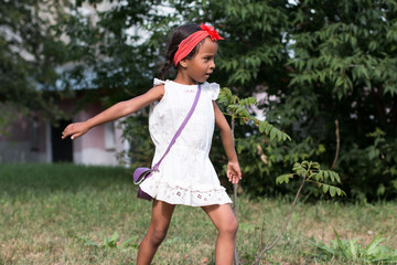 Small tan girl outdoor in a summer day