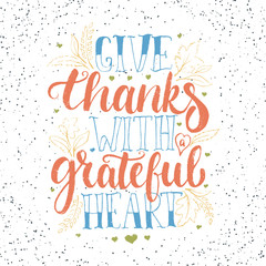 Give thanks with a greatful heart - Thanksgiving day lettering calligraphy phrase with leaves and hearts. Autumn greeting card isolated on the white background.
