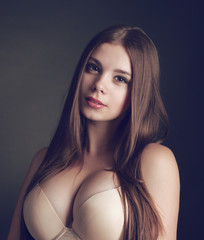 Portrait of a young beautiful brunette girl with long  hair