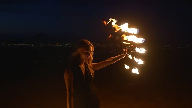 Woman strikes fire poi making sparks