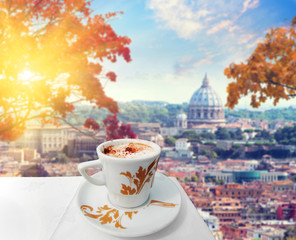 Cup of coffee in Rome with view of st Peters cathedral, Italy . Hot drink in autumn time. Colored...