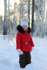 little girl walking through the forest frosty winter day