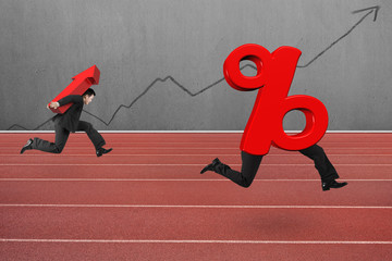 Man carrying arrow symbol running after percentage sign
