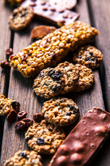 Set of sweets. Chocolate bars and granola on a wooden background with milk chocolates. Food, candy, snack