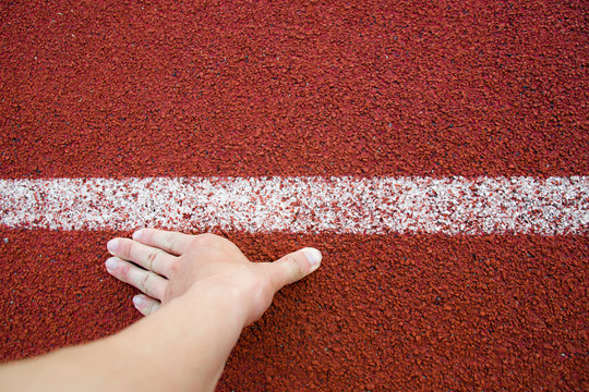 Top view Runner Man Hand in position Track White Lines of Start Running at sport stadium