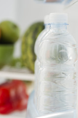 Bottles with water in refrigerator