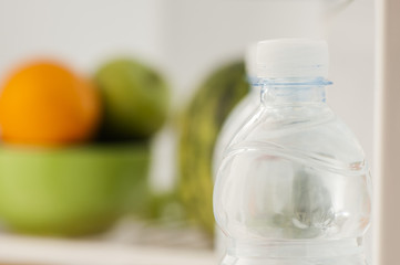 Obraz na płótnie Canvas Bottles with water in refrigerator
