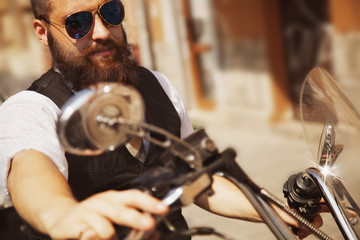 Serious Bearded Biker Man Sitting on a Motorcycle