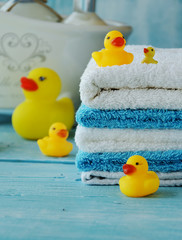 stack of colorful towels and bath duck on the table