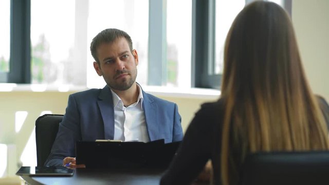 the employer asks questions to the woman in the interview