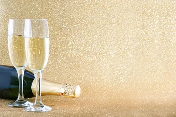Papier Peint photo Lavable Alcool Champagne bottle with glass cups on brilliant golden background    