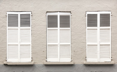 colsed white blinds in windows of old medieval bruges in belgium