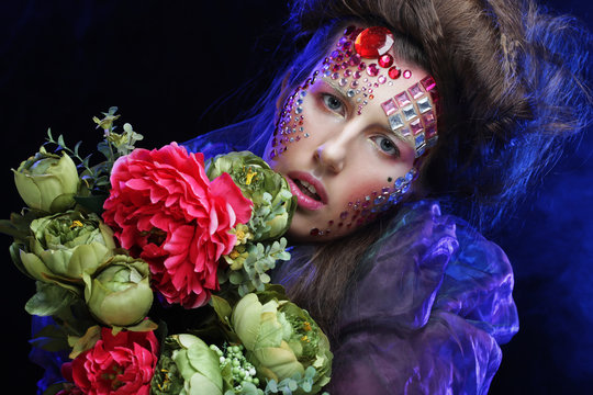 woman in creative image  with big flowers.