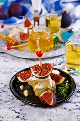 Pieces of Camembert and figs