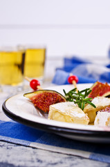 Pieces of Camembert and figs