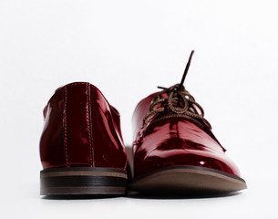Red patent leather shoes on a white background