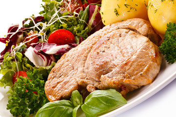 Fried steak, boiled potatoes and vegetable salad 