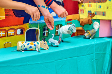  Children showing puppet show with self-made dolls 