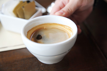 Black coffee on wood background in coffee shop