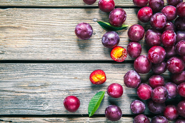 fresh plums on wooden table