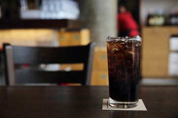 Cola drinking on wood background