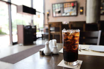 Cola drinking on wood background