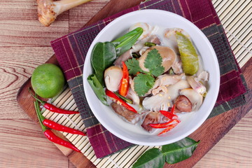 Chicken and galangal in coconut milk soup and herb . Top view