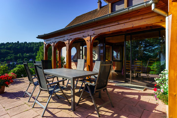 Fototapeta na wymiar Beautiful guesthouse with terrace in Alsace, France. Alpine styl