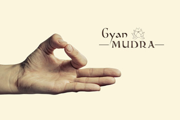 Image of woman hand in gyan mudra. Gesture is  isolated on toned background.