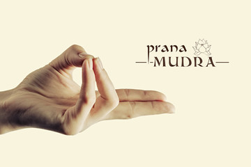 Image of woman hand in prana mudra. Gesture is  isolated on toned background.