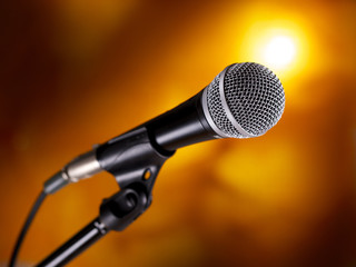 Microphone on stand against a colorful background