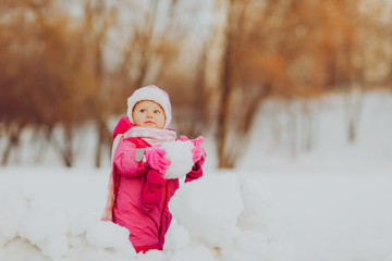 cute happy little girl play in winter