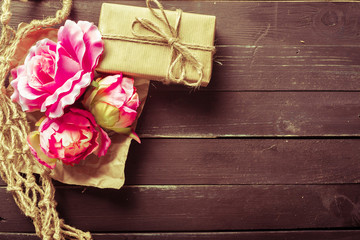 flowers and a notebook on wooden background