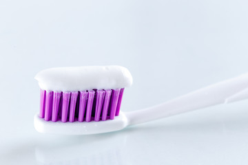 sqweezed purple toothbrush on white background